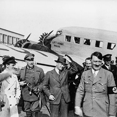 Adolf Hitler and other members of the National Socialist part in front of a Lufthansa plane.