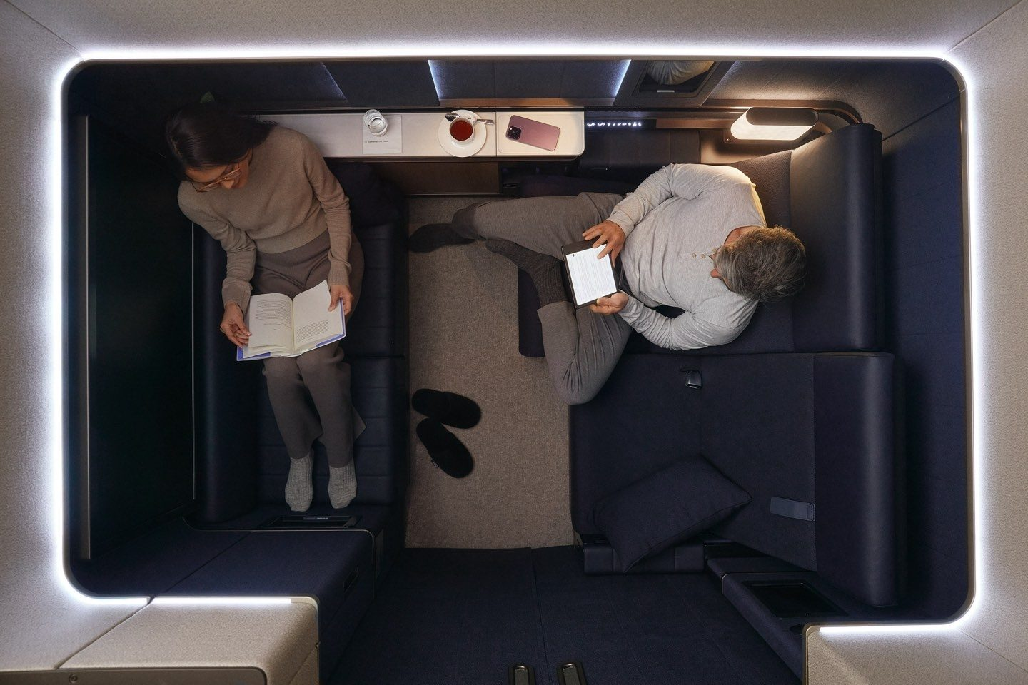 Overhead view of two passengers in a cramped Suite Plus.
