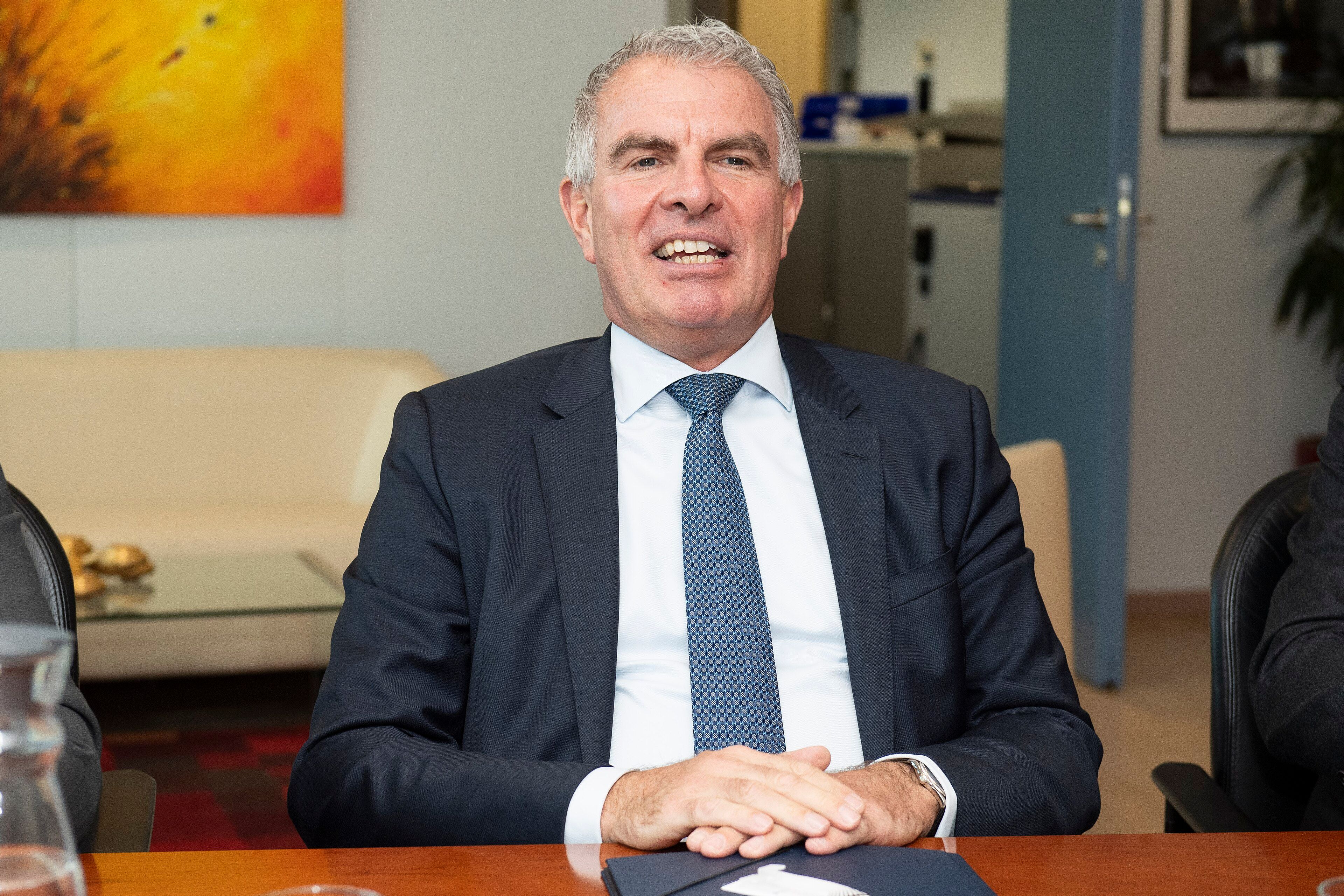 Carsten Spohr, Lufthansa's CEO, in suit and tie, seated at a conference table.