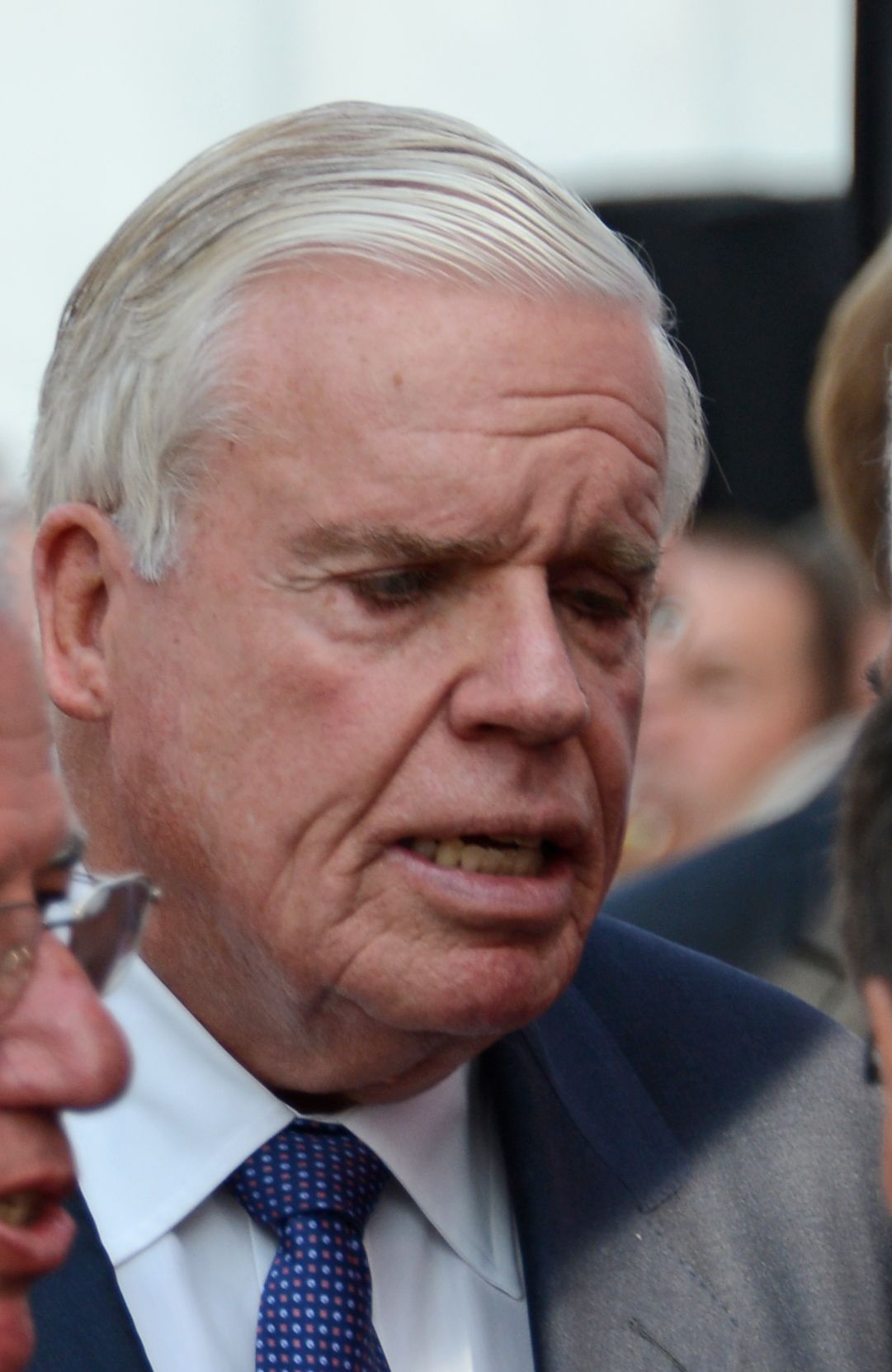 Close up of Klaus-Michael Kühne at an event, wearing a suit and tie.