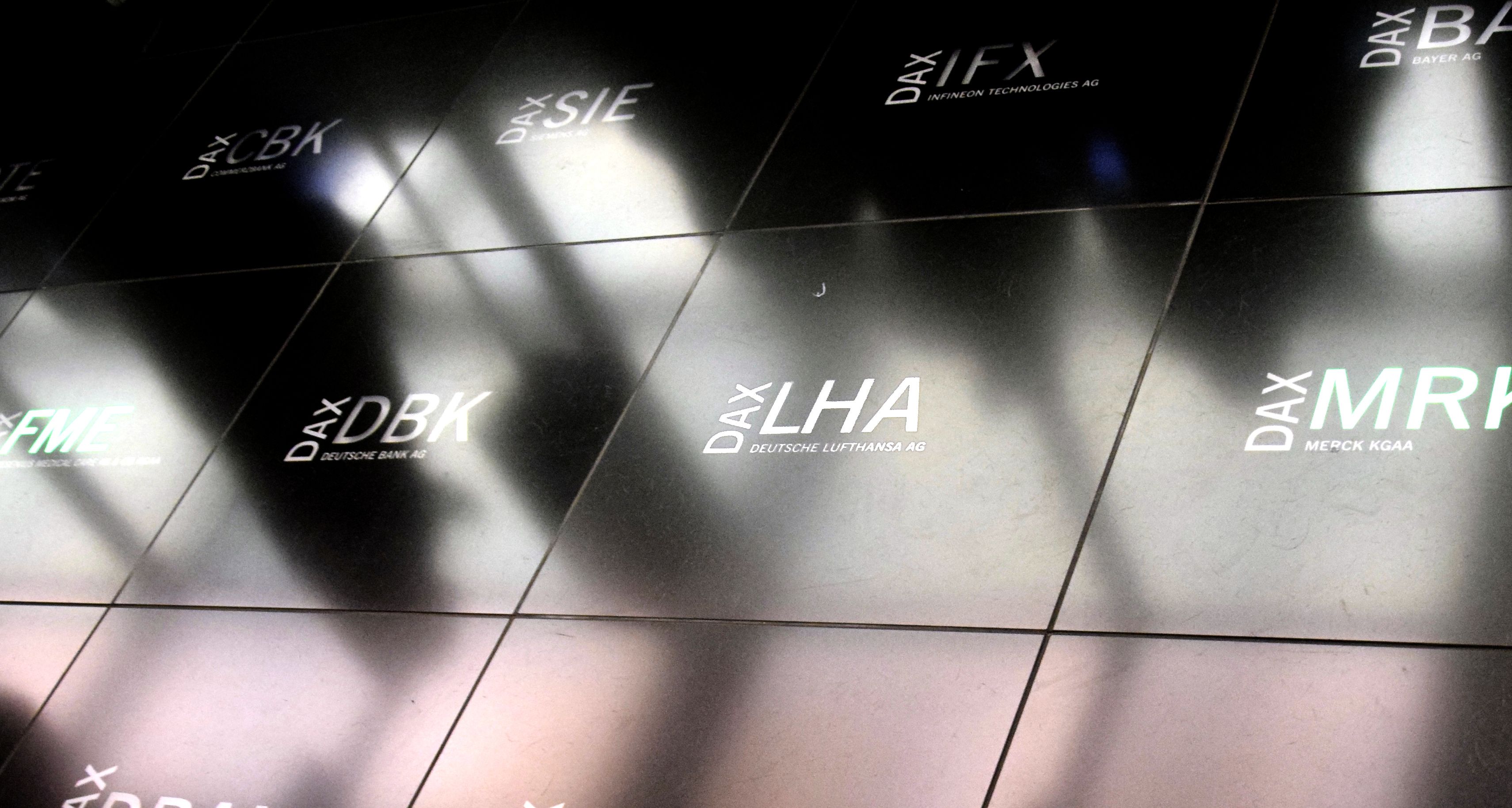 DAX stock ticker board with company logos, including Lufthansa (LHA).