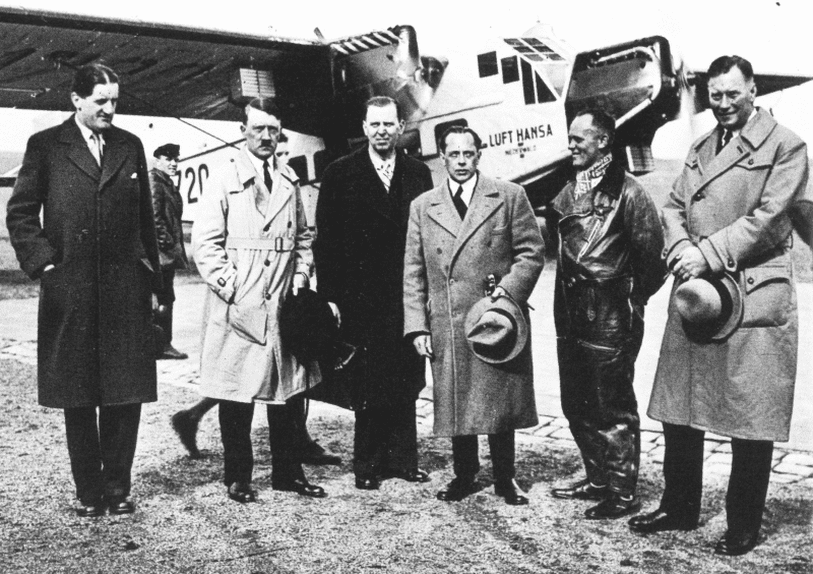 Adolf Hitler and other members of the National Socialist part in front of Hitler's Lufthansa plane, D-1720.