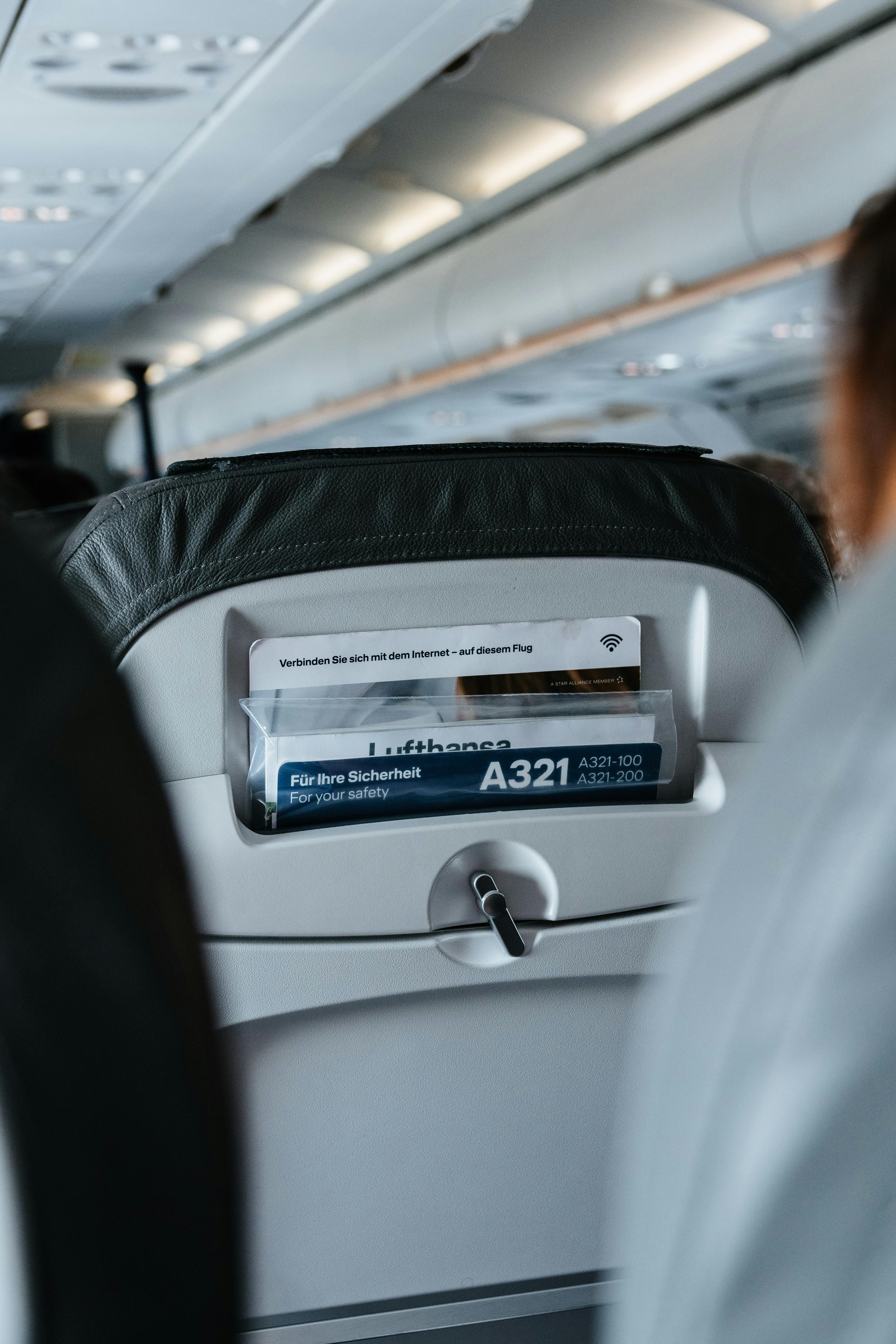 Lufthansa A321 seatback pocket with safety card and Wi-Fi info.