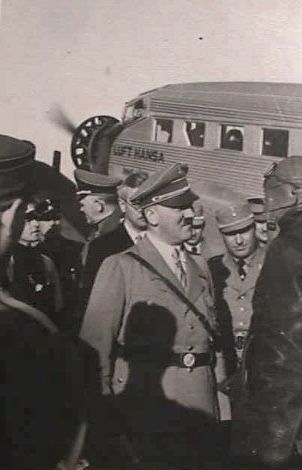 Adolf Hitler with officials in front of a Lufthansa plane