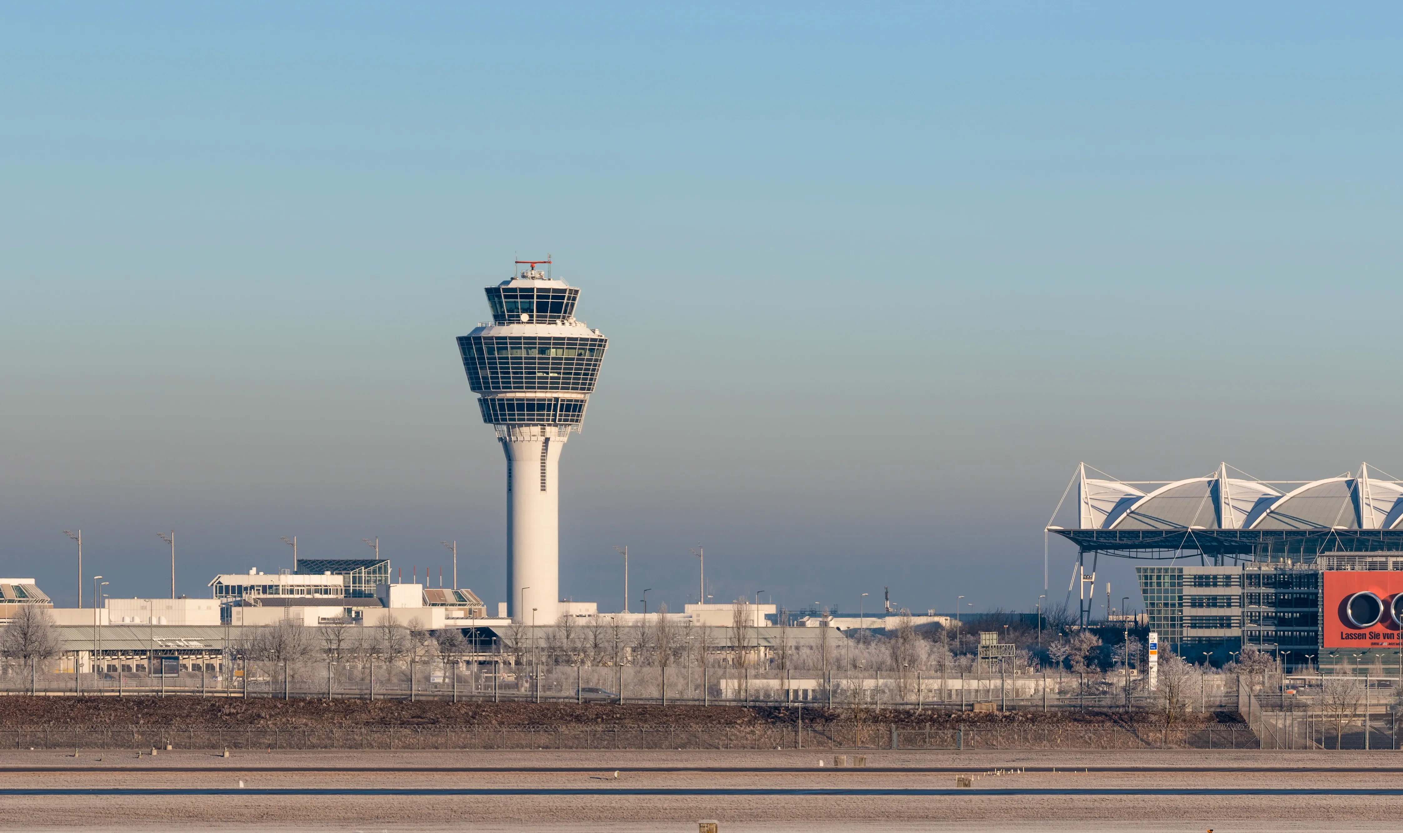 Munich Airport control tower and terminal on a clear, cold day. Frosty ground.